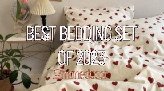 Promotional image for the 'Best Bedding Set of 2023' featuring a bedding set with a white background and red heart patterns. The text 'BEST BEDDING SET OF 2023' is prominently displayed at the top