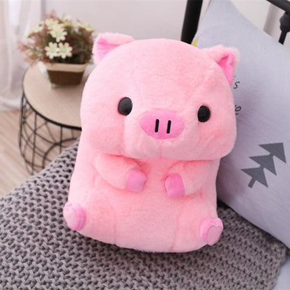 The pink piggy plushie placed on a grey woven surface beside a plant, providing a cozy home decor vibe.