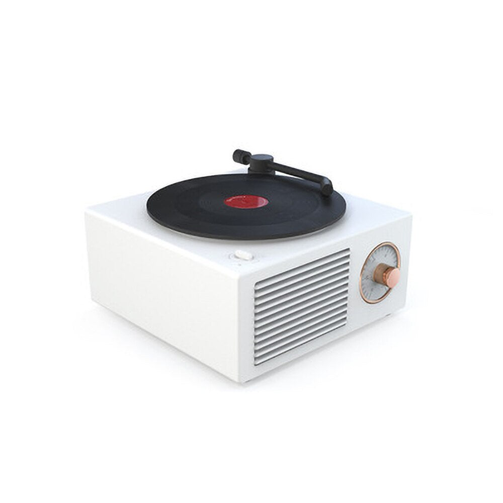 A white retro Bluetooth speaker with a vinyl record design on top, echoing a classic turntable look with a modern twist. It has a black tonearm and a copper-colored control knob, blending seamlessly with contemporary decor.