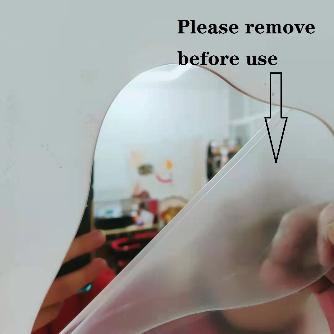 A person peeling off a protective film from a curved mirror with text overhead saying "Please remove before use" indicating the item is new and needs preparation before use.