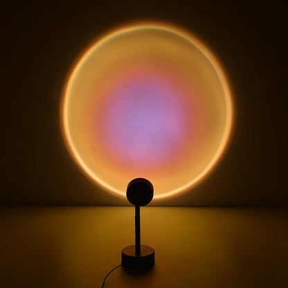 A glowing red and orange light cast from a circular lamp on a stand creates a warm, sun-like aura on a plain wall.
