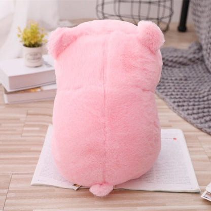 The rear view of the piggy plushie, showing the back and tail details on an open book.