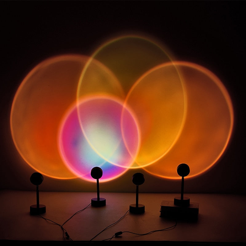 Overlapped sunset projectors that show how their light blends to create new colors where the circles intersect, with the central area showing a mixture of all the hues.