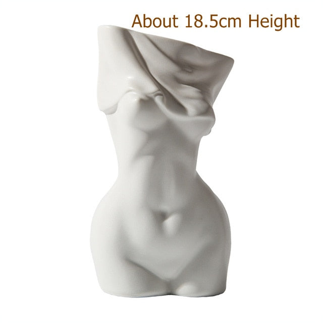 A frontal view of the white ceramic vase showcasing the approximate height of 18.5 cm, with a focus on the detailed curves and smooth surface of the sculpture.