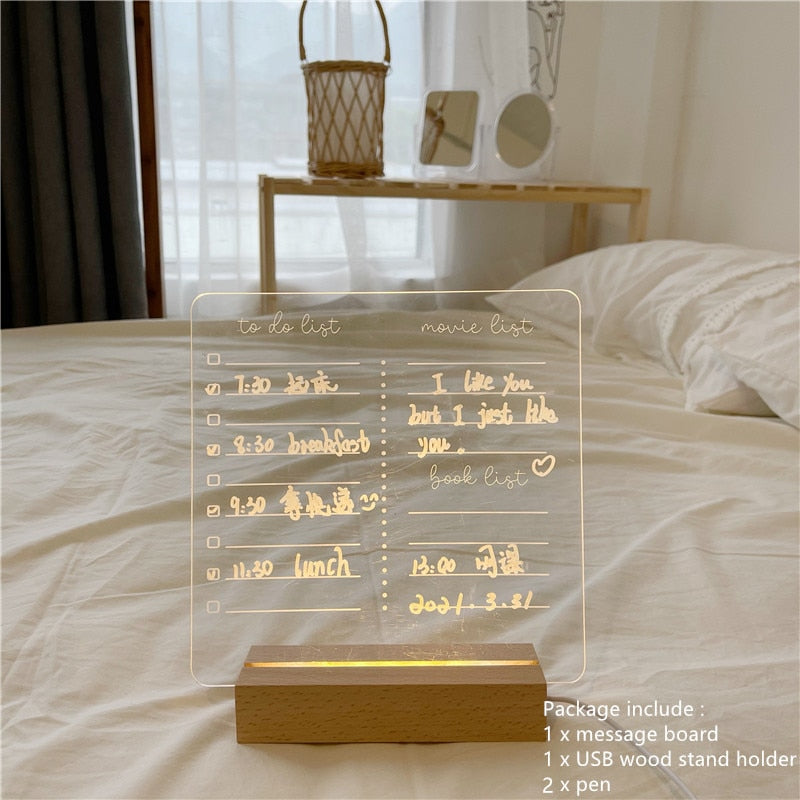 A clear LED memo board with pre-written sections for a to-do list and a movie list, filled with tasks and preferences in golden handwritten font. The board, showcasing a warm glow, is placed in a softly lit bedroom, providing a functional yet decorative element.