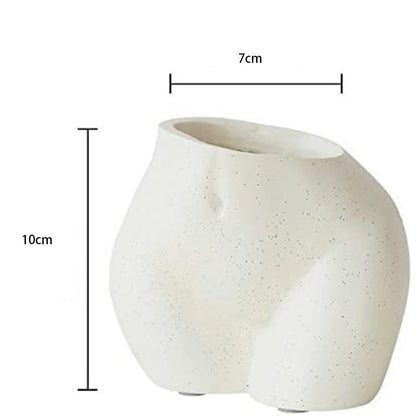 A speckled white ceramic vase with a unique, abstract form resembling human curves, with dimensions labeled showing a width of 7 cm and a height of 10 cm.