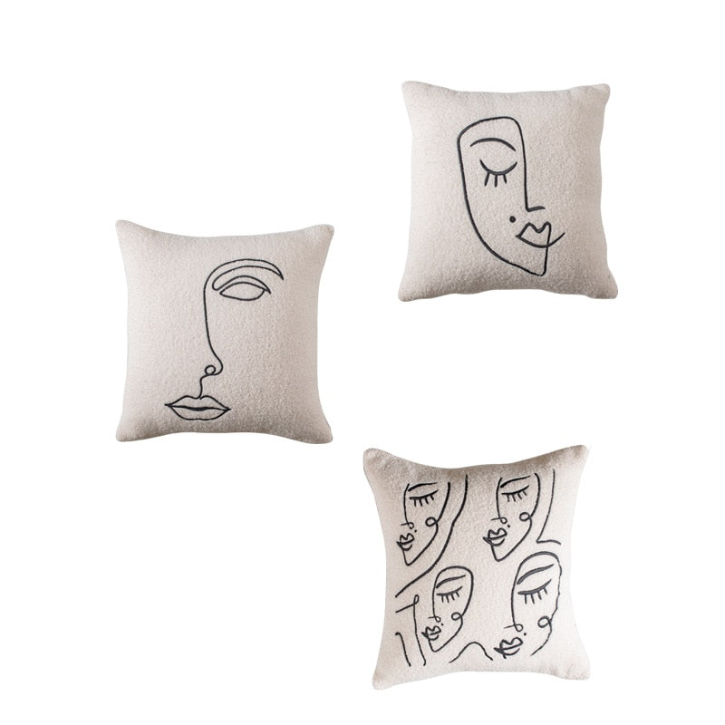 A collection of three off-white pillowcases, each adorned with a unique, black line art drawing of faces, displayed against a white background. The line art creates a modern, minimalist appearance, aligning with the 'Art Hoe' design philosophy. These pillowcases would complement various home decor styles including 'Boho', 'Coquette', 'Cottagecore', 'Danish Pastel', and could be a stylish addition to 'Dorm Room', 'Dreamy', 'Feminine', and 'Relaxing Room' decor settings.