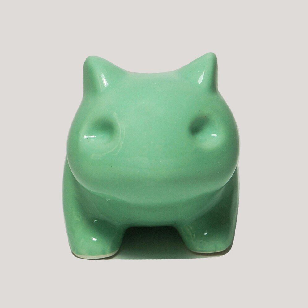 Front view of a green ceramic frog planter, suitable for indie room or boho room decor collections, adding a playful touch to any space.