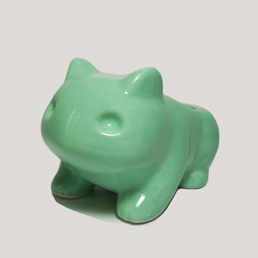 A minimalist green frog flower pot from the side view, ideal for art hoe room decor or to brighten up a cozy corner with cheerful room decor.