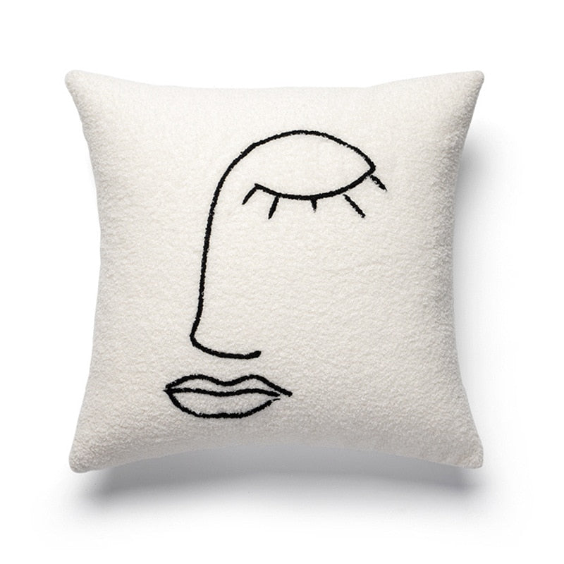 A square pillowcase featuring a textured, off-white fabric with a simple, yet elegant, black line art of a face with a closed eye, nose, and full lips. This 'Art Hoe Pillow Case' fits into various interior design categories, such as 'Art Hoe Room Decor', 'Bedding', 'Boho Room Decor', 'Coquette Room Decor', 'Cottagecore', 'Danish Pastel', 'Dorm Room Decor', 'Dreamy Room', 'Feminine Decor', and 'Relaxing Room Decor', making it versatile for an array of home aesthetics.