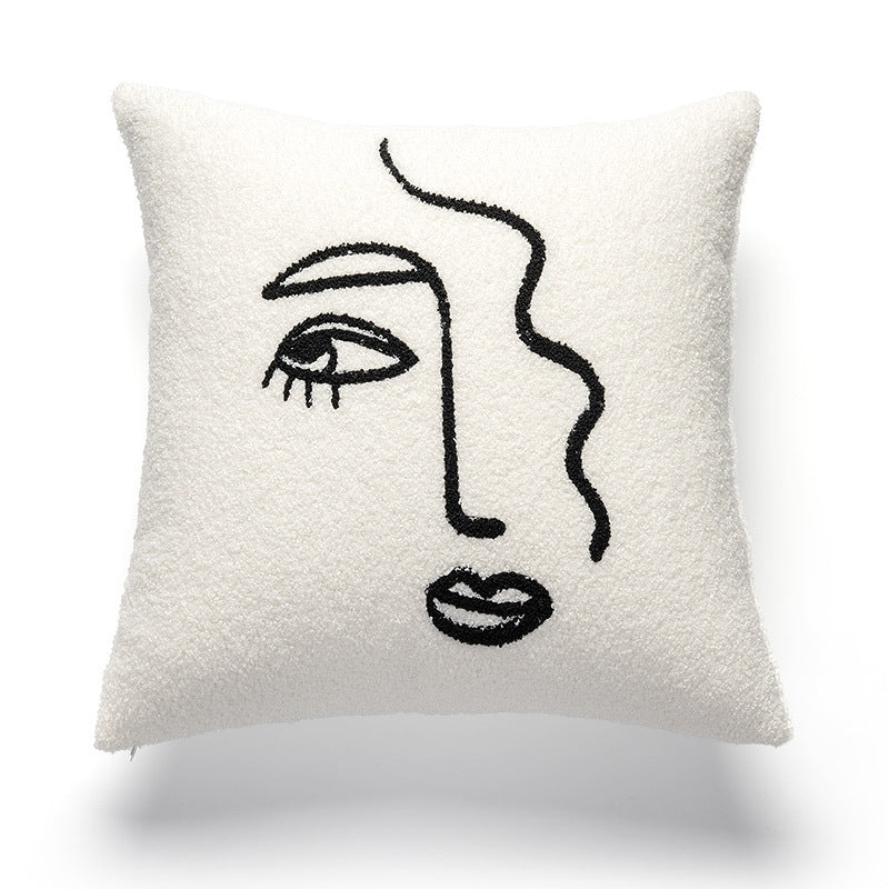 A white pillowcase with a textured surface, adorned with a black abstract line art design that depicts a stylized female face with one visible eye, eyebrow, nose, and a plump lip. This artistic pillowcase would complement a variety of decorative themes such as 'Art Hoe', 'Boho', 'Coquette', 'Cottagecore', 'Danish Pastel', and is ideal for adding a chic and thoughtful accent to dorms, feminine spaces, or any room seeking a touch of dreamy and relaxing decor.