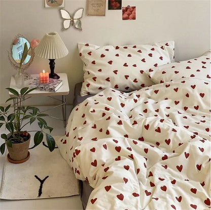 room with bed set with hearts model