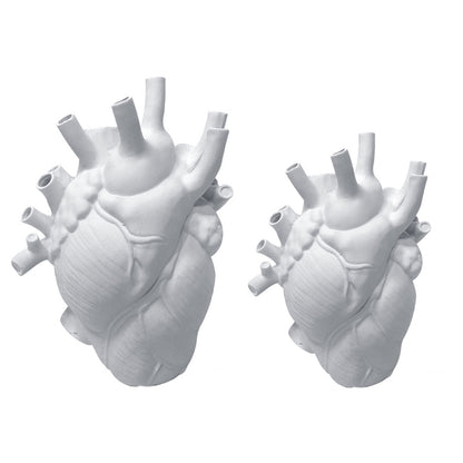 Two white ceramic vases side by side on a white background, designed to replicate the intricate details of a human heart with multiple tube-like openings.